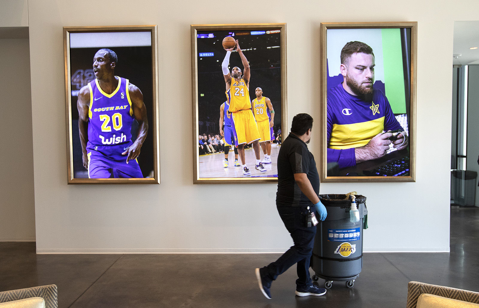 Left to right: Photographs of Andre Ingram of the South Bay Lakers, Kobe Bryant, of the Los Angeles Lakers, and "SafiyauYa" Shane Farrar of the Los Angeles Lakers NBA 2K team, appear on the wall inside the lobby of the Los Angeles Lakers practice facility in El Segundo.